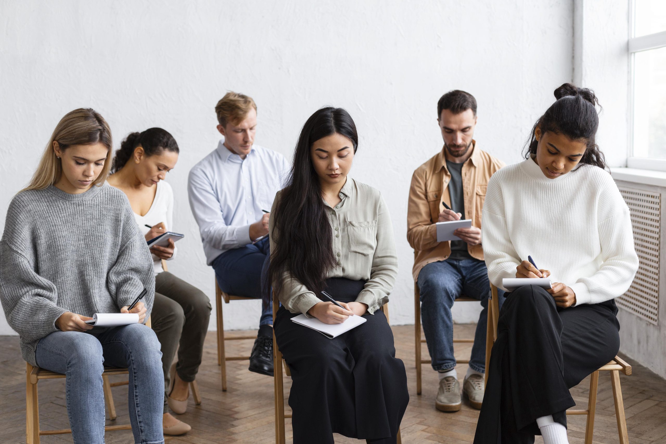 people taking notes group therapy session